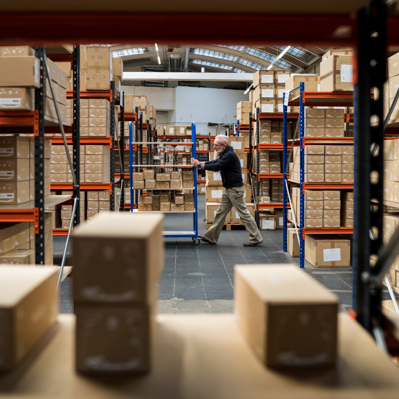 an employee in the wildling warehouse transporting packages