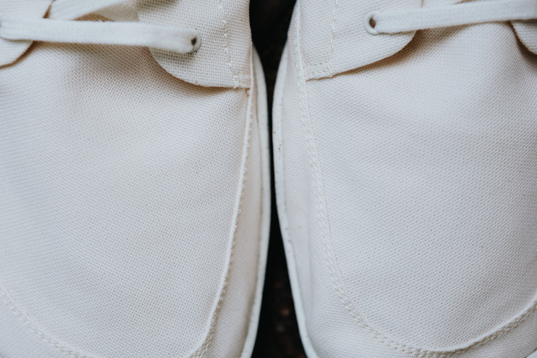 A close-up of a pair of Tanuki Niji highlights the shoes’ white upper.