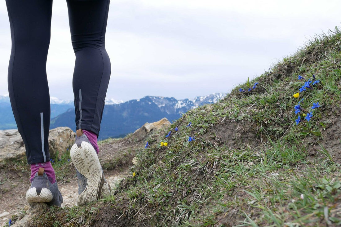 hiker standing in front of mountain view 